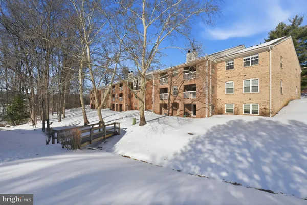 a view of a building with a snow on the road
