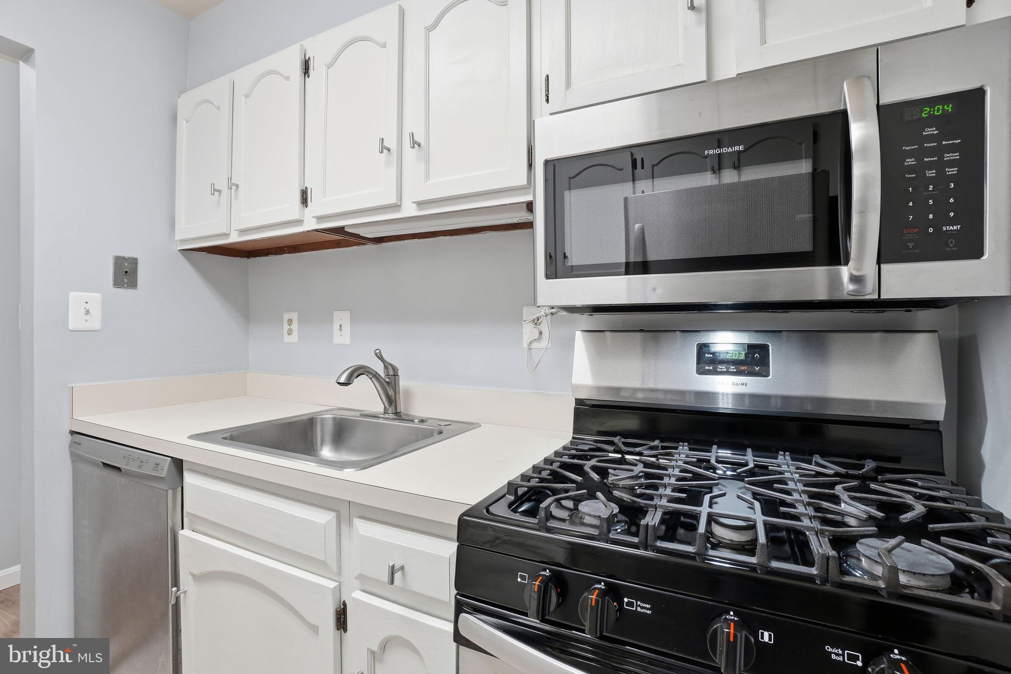 5902 Cove Landing Road, Unit 203 Burke, VA 22015 - Photo 9 of 25 a kitchen with microwave stove and cabinets
