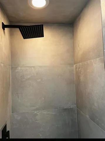 a bathroom with a black white checkered floor