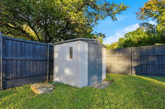 a view of a backyard with a small cabin