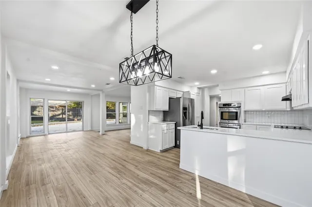 a kitchen with stainless steel appliances granite countertop a sink and cabinets