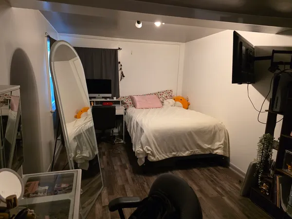 a bedroom with a bed and a flat tv screen