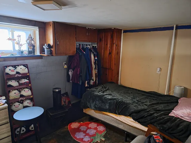a bedroom with a bed and a dresser