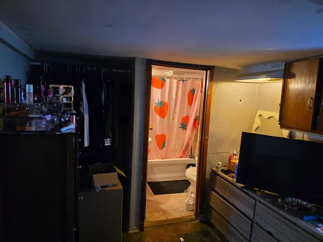 a living room with flat screen tv and a floor to ceiling window