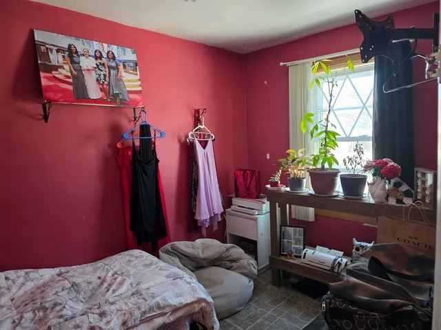 a bedroom with furniture and a window