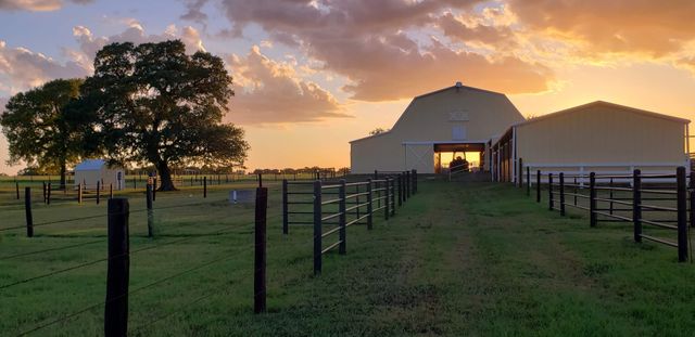 a row of table and chairs with wooden fence
