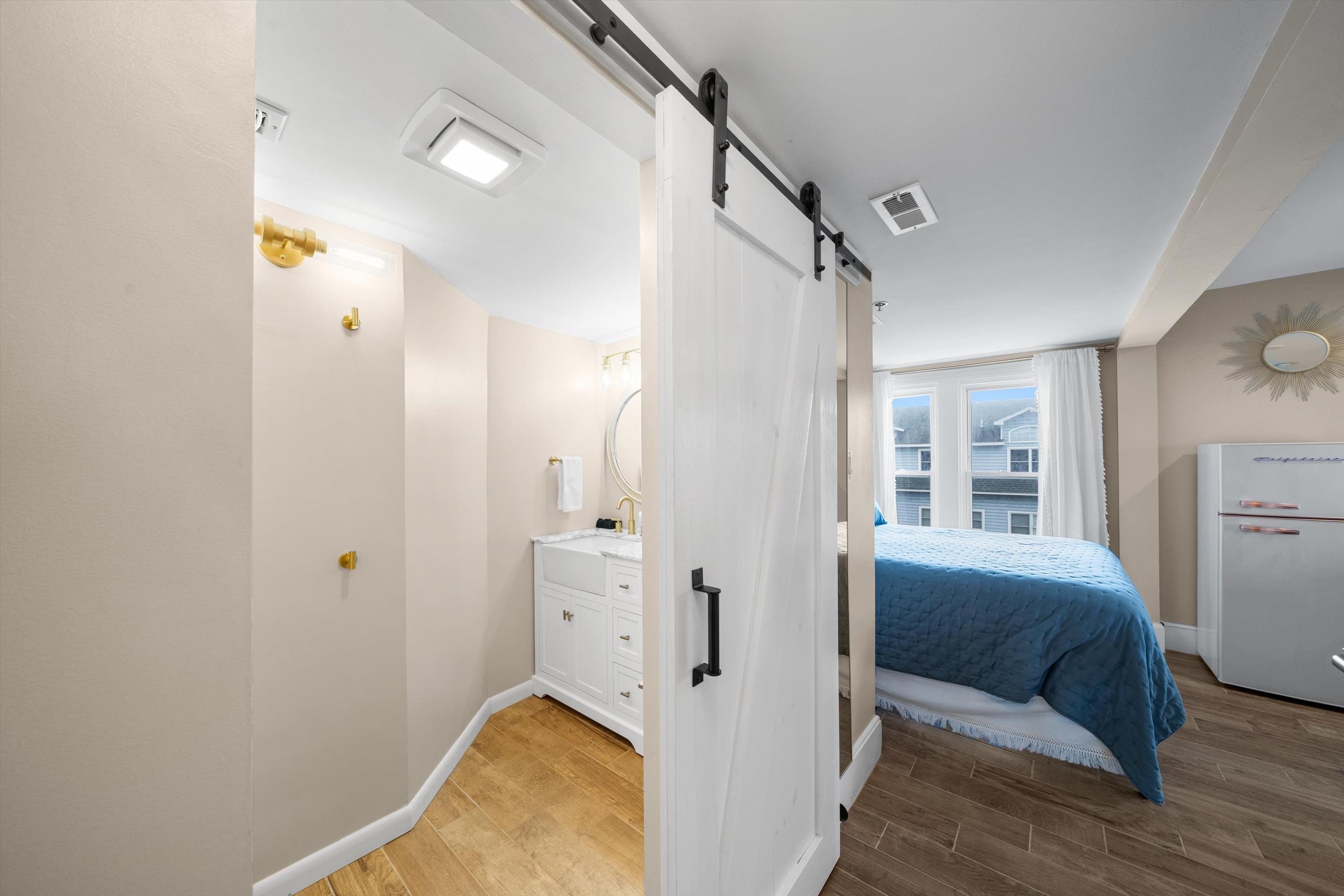 4600 Landis Avenue, Unit 3B Sea Isle City, NJ 08243 - Photo 14 of 29 a bedroom with a bed and wooden floor