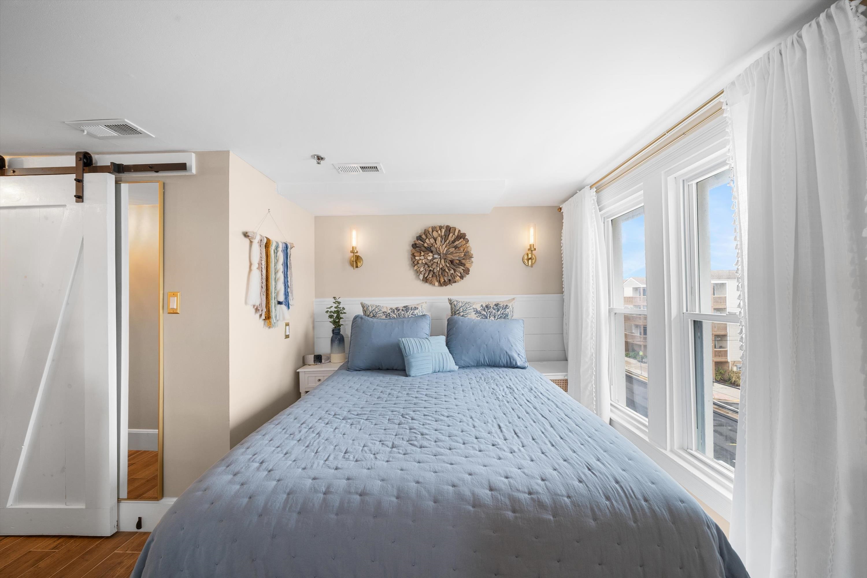 4600 Landis Avenue, Unit 3B Sea Isle City, NJ 08243 - Photo 7 of 29 a bedroom with a large bed and wooden floor