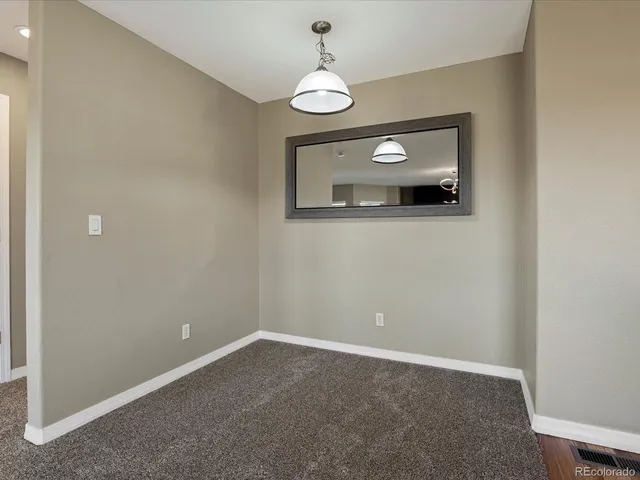 a large kitchen with a refrigerator and a stove top oven