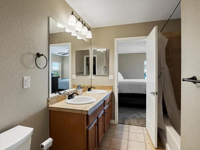 a living room with furniture a rug and a flat screen tv