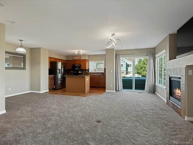 a view of a kitchen with a sink and a fireplace
