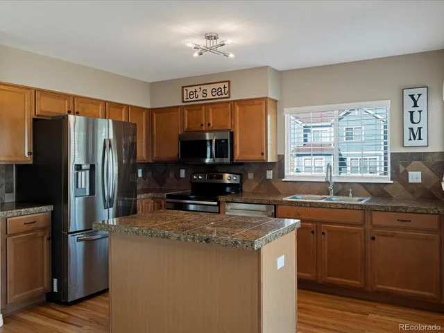 a kitchen with granite countertop a sink and a window