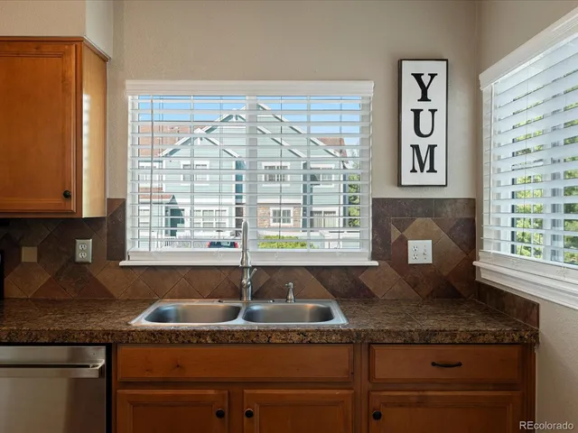 a kitchen with kitchen island granite countertop a sink appliances cabinets and counter space