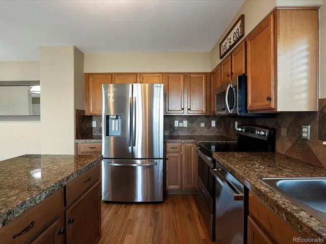 a kitchen with metallic refrigerator and cabinet
