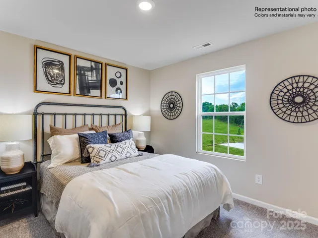 a bedroom with bed and a wooden floor