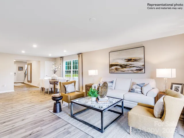 a living room with fireplace furniture and a wooden floor