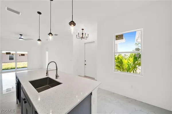 a kitchen with a refrigerator a sink and a stove