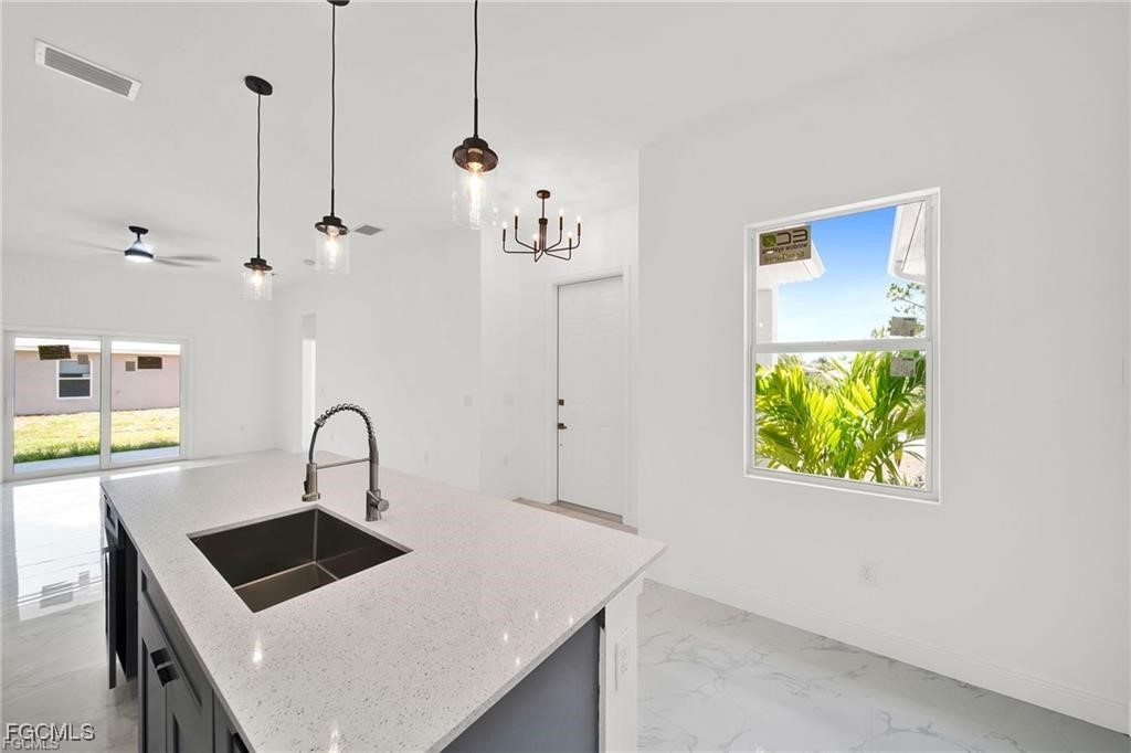 4768 Nelson Drive Lehigh Acres, FL 33973 - Photo 14 of 30 a kitchen with a refrigerator a sink and a stove