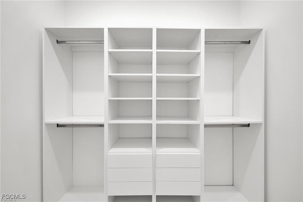 4768 Nelson Drive Lehigh Acres, FL 33973 - Photo 19 of 30 a view of walk in closet with empty racks