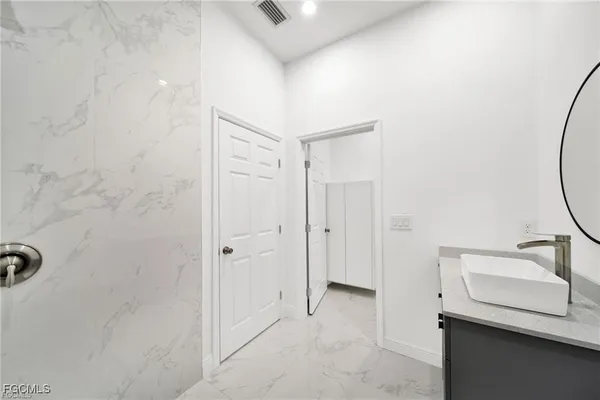 a bathroom with a sink and a mirror