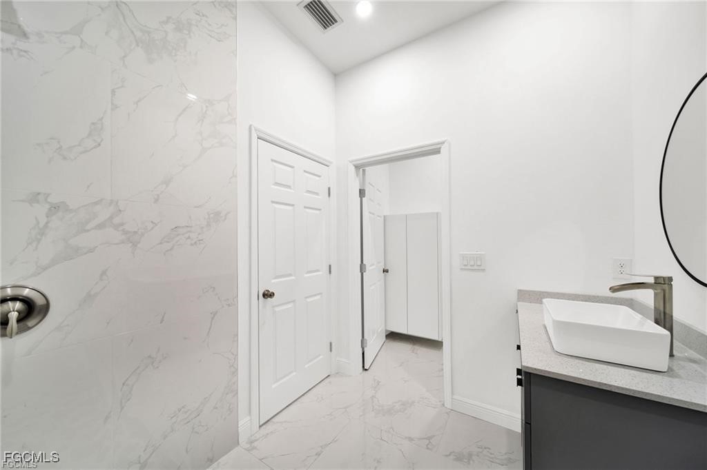 4768 Nelson Drive Lehigh Acres, FL 33973 - Photo 21 of 30 a bathroom with a sink and a mirror