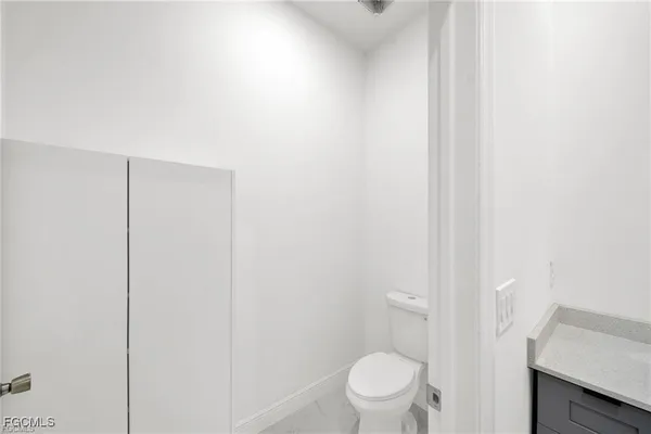 a white toilet sitting next to a shower