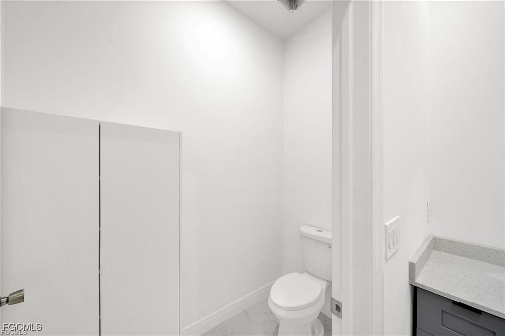 4768 Nelson Drive Lehigh Acres, FL 33973 - Photo 22 of 30 a white toilet sitting next to a shower