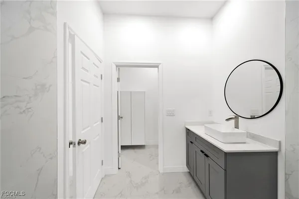 a bathroom with a sink and a mirror