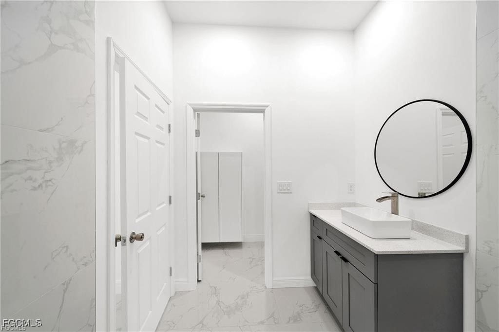 4768 Nelson Drive Lehigh Acres, FL 33973 - Photo 23 of 30 a bathroom with a sink and a mirror