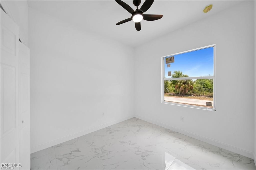 4768 Nelson Drive Lehigh Acres, FL 33973 - Photo 27 of 30 an empty room with a window