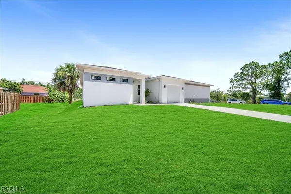 a backyard of a house with lots of green space and plants