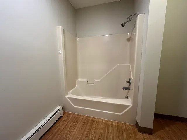 a bathroom with a tub and shower