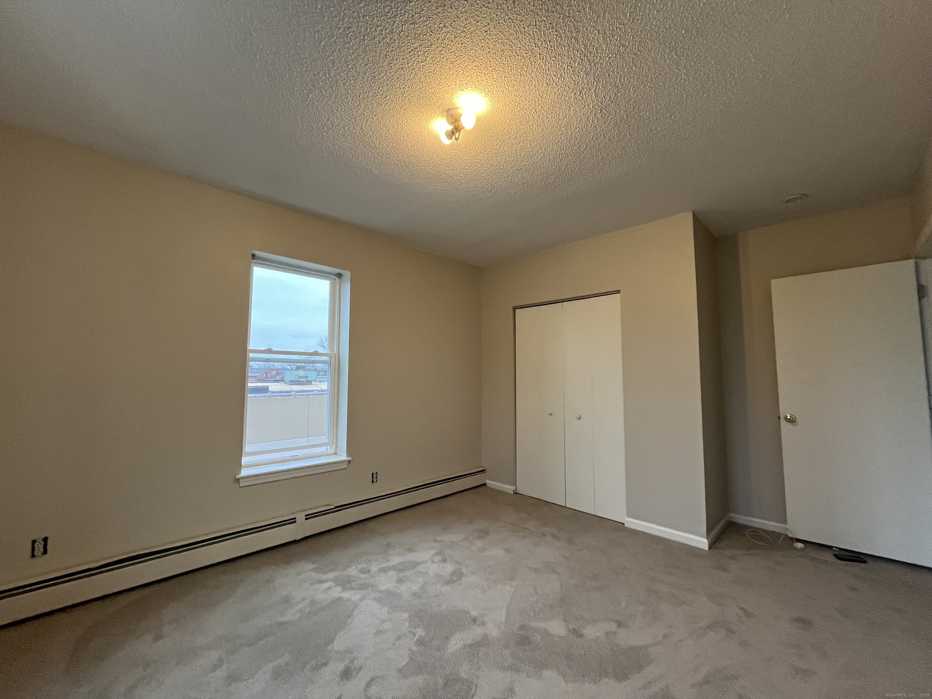 19 Divinity Street, Unit 3E Bristol, CT 06010 - Photo 13 of 16 an empty room with windows