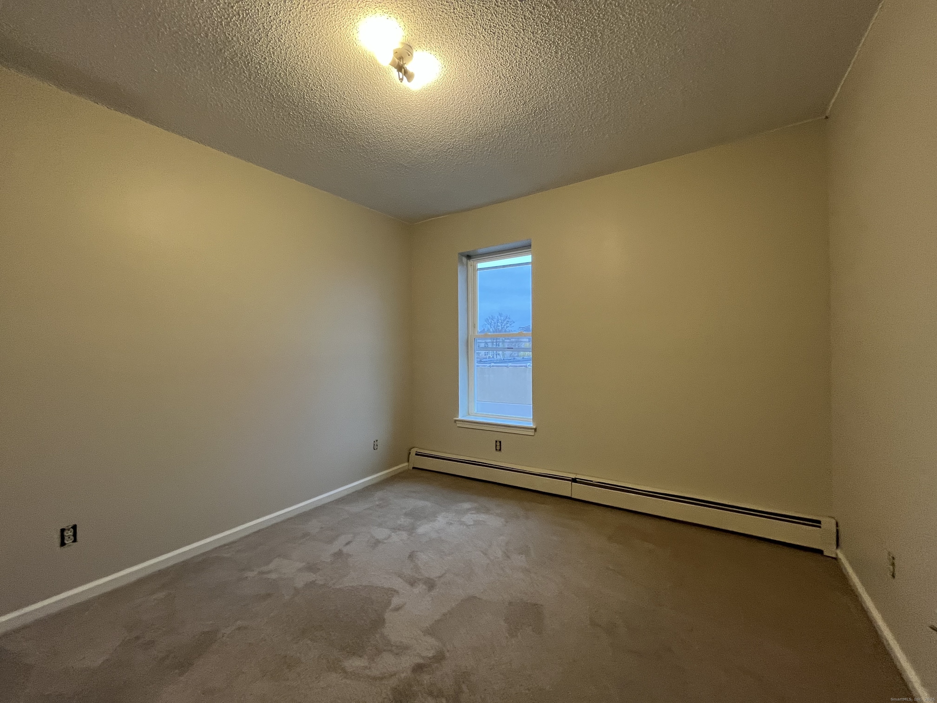 19 Divinity Street, Unit 3E Bristol, CT 06010 - Photo 14 of 16 an empty room with a empty space and window