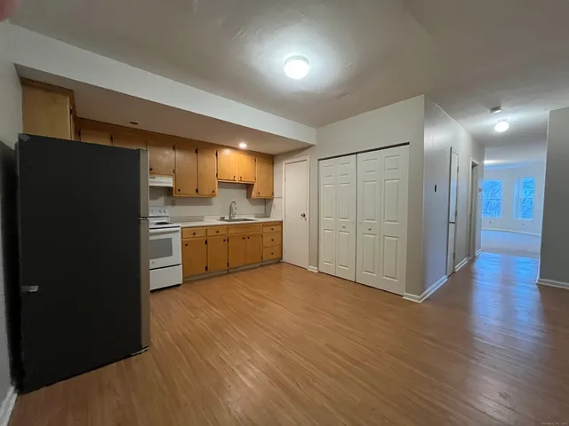 a view of a kitchen with a sink and a refrigerator
