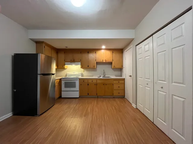 a kitchen with stainless steel appliances a refrigerator a sink a stove a microwave and cabinets