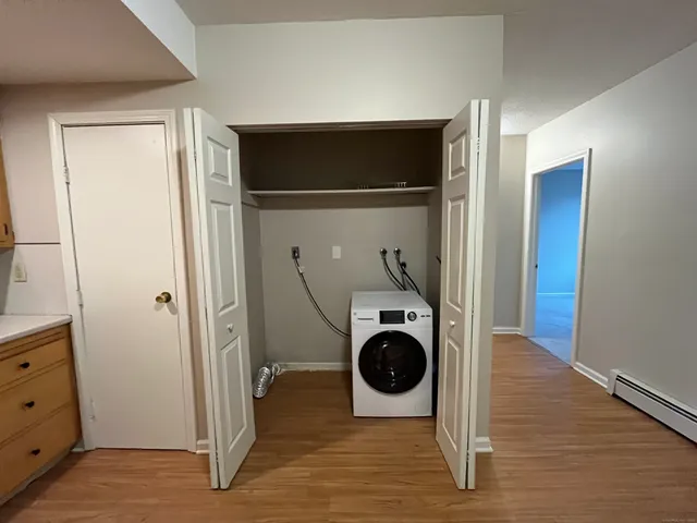 a view of a storage & utility room with wooden floor