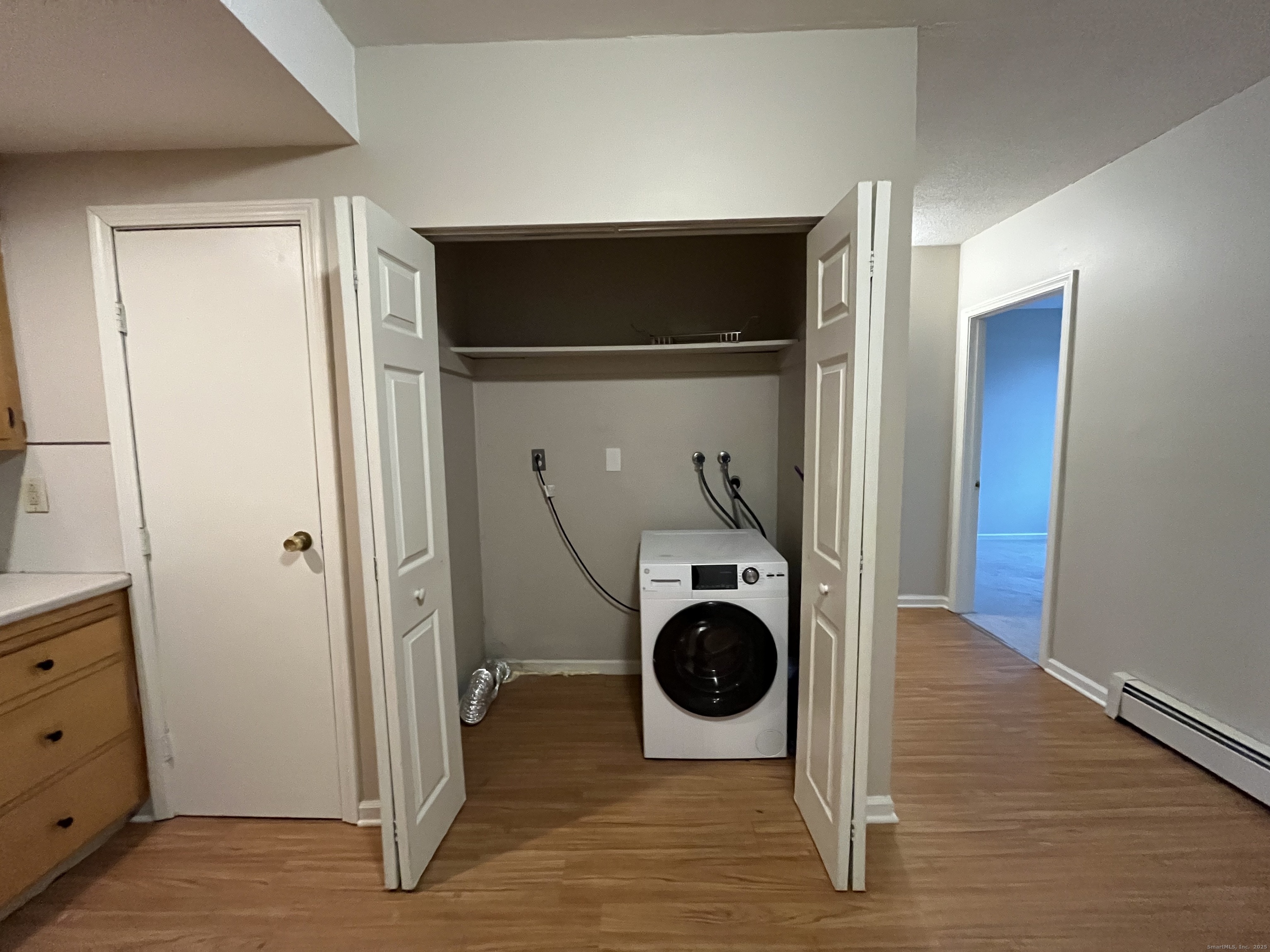 19 Divinity Street, Unit 3E Bristol, CT 06010 - Photo 6 of 16 a view of a storage & utility room with wooden floor