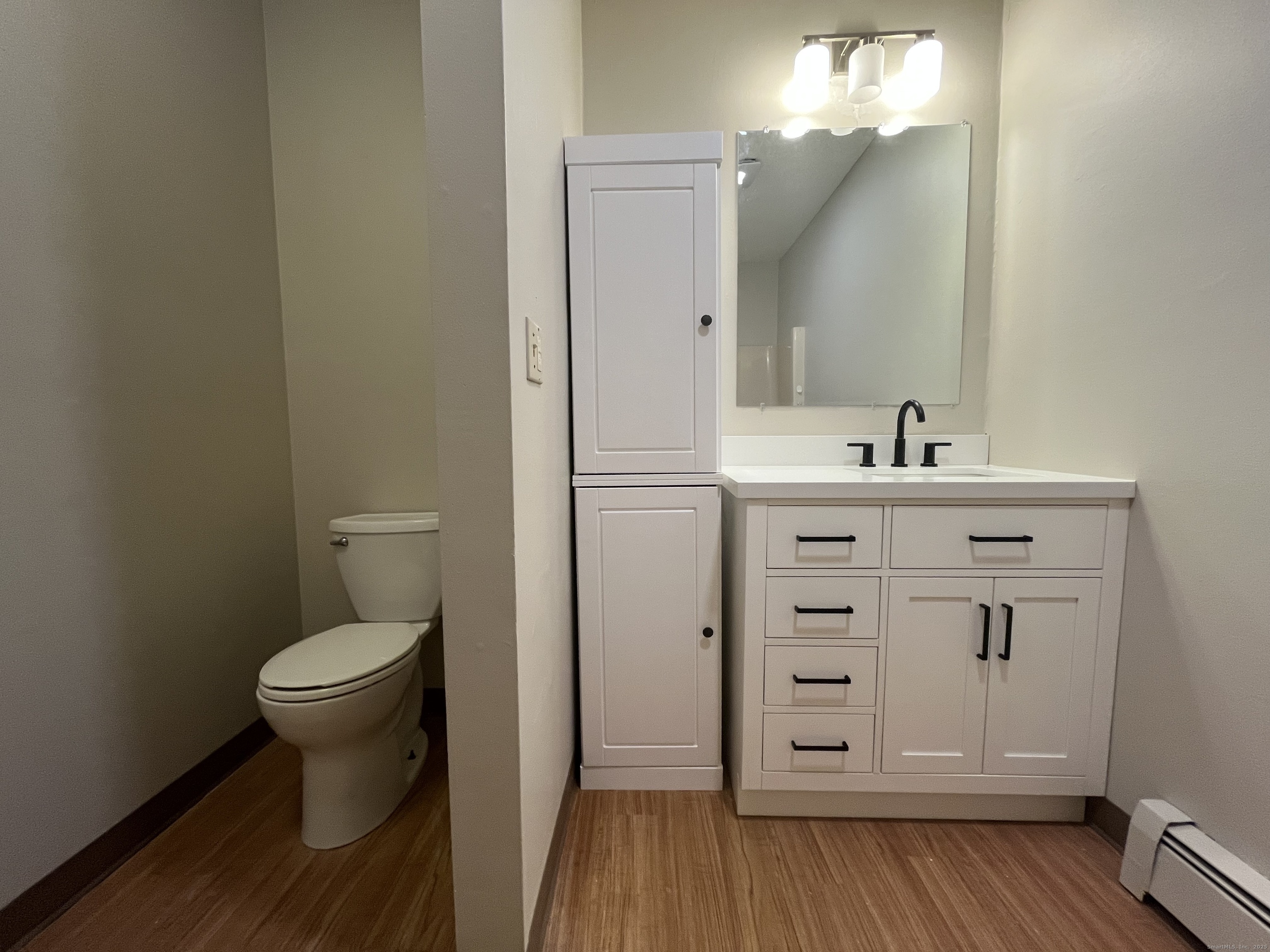 19 Divinity Street, Unit 3E Bristol, CT 06010 - Photo 10 of 16 a bathroom with a toilet sink and mirror