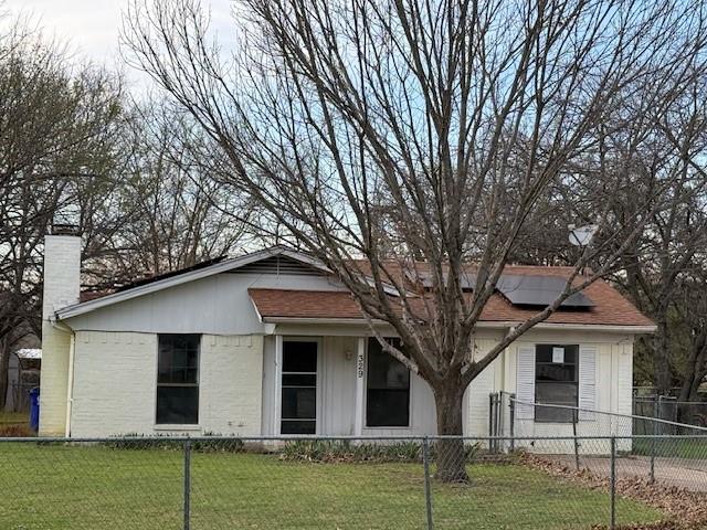 a house that has a tree in front of the house