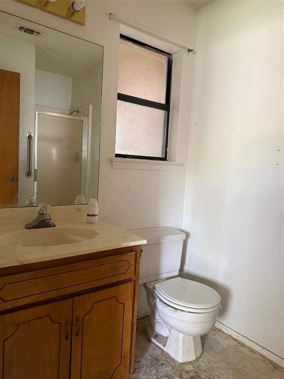 329 Walnut Avenue Azle, TX 76020 - Photo 13 of 13 a bathroom with a toilet a sink and mirror