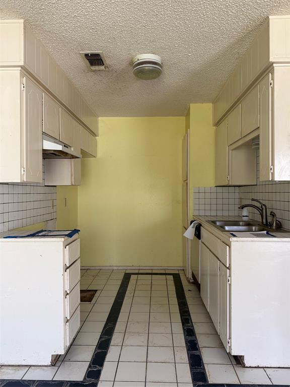 329 Walnut Avenue Azle, TX 76020 - Photo 10 of 13 a bathroom with a sink a toilet and a mirror