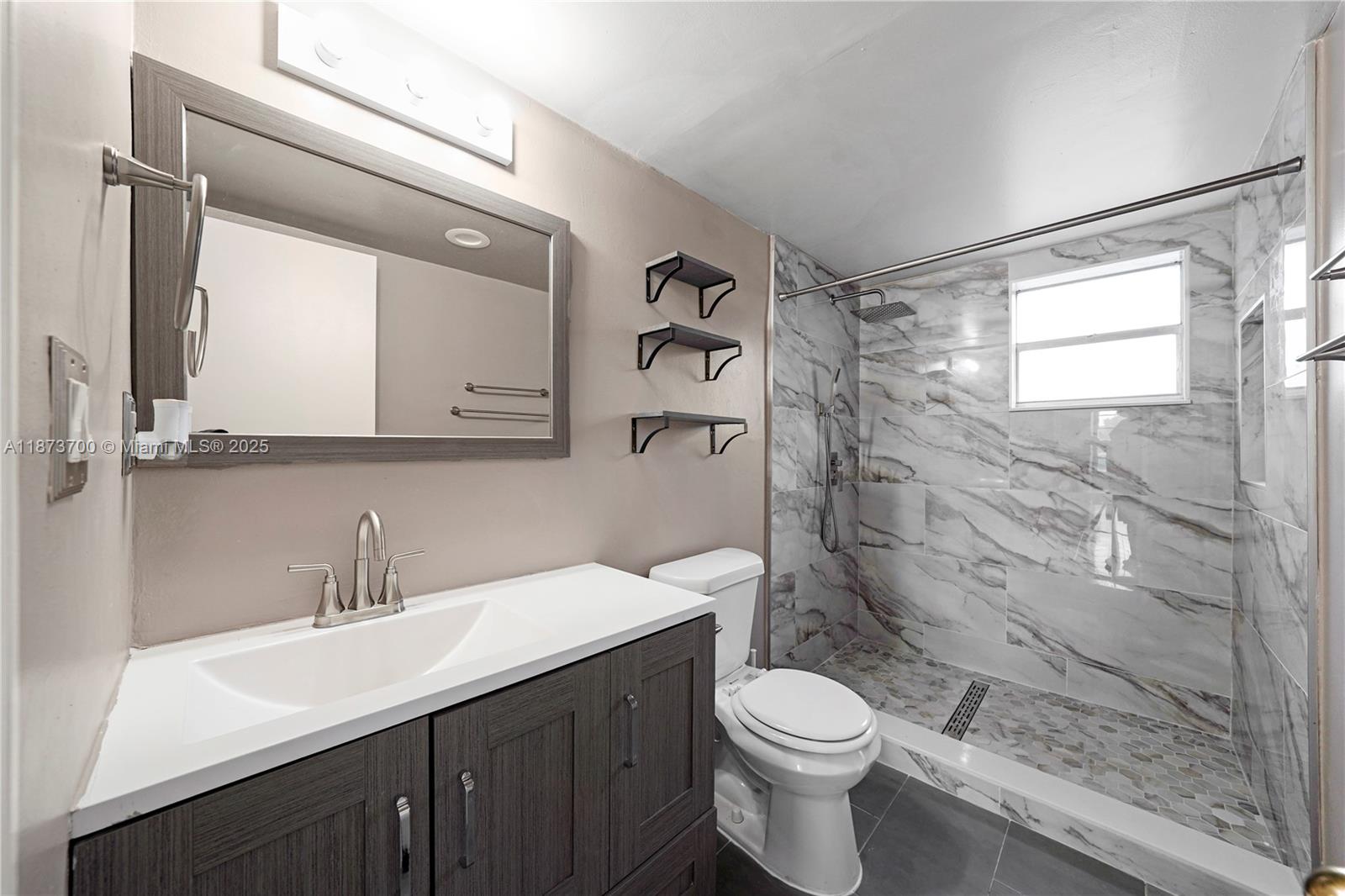 9491 Evergreen Place, Unit 207 Davie, FL 33324 - Photo 16 of 42 a bathroom with a sink a toilet and shower