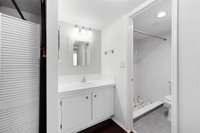 a bathroom with a sink a mirror and a shower