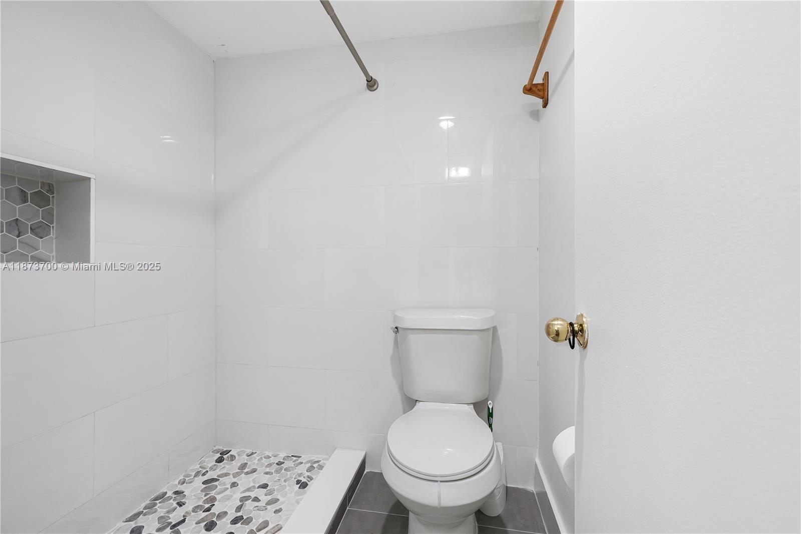 9491 Evergreen Place, Unit 207 Davie, FL 33324 - Photo 21 of 42 a white toilet sitting next to a shower