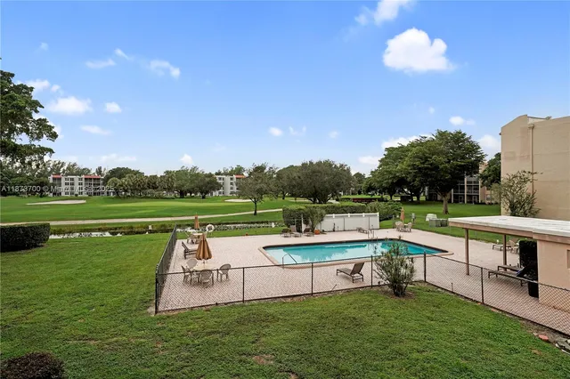 a view of a garden with lawn chairs
