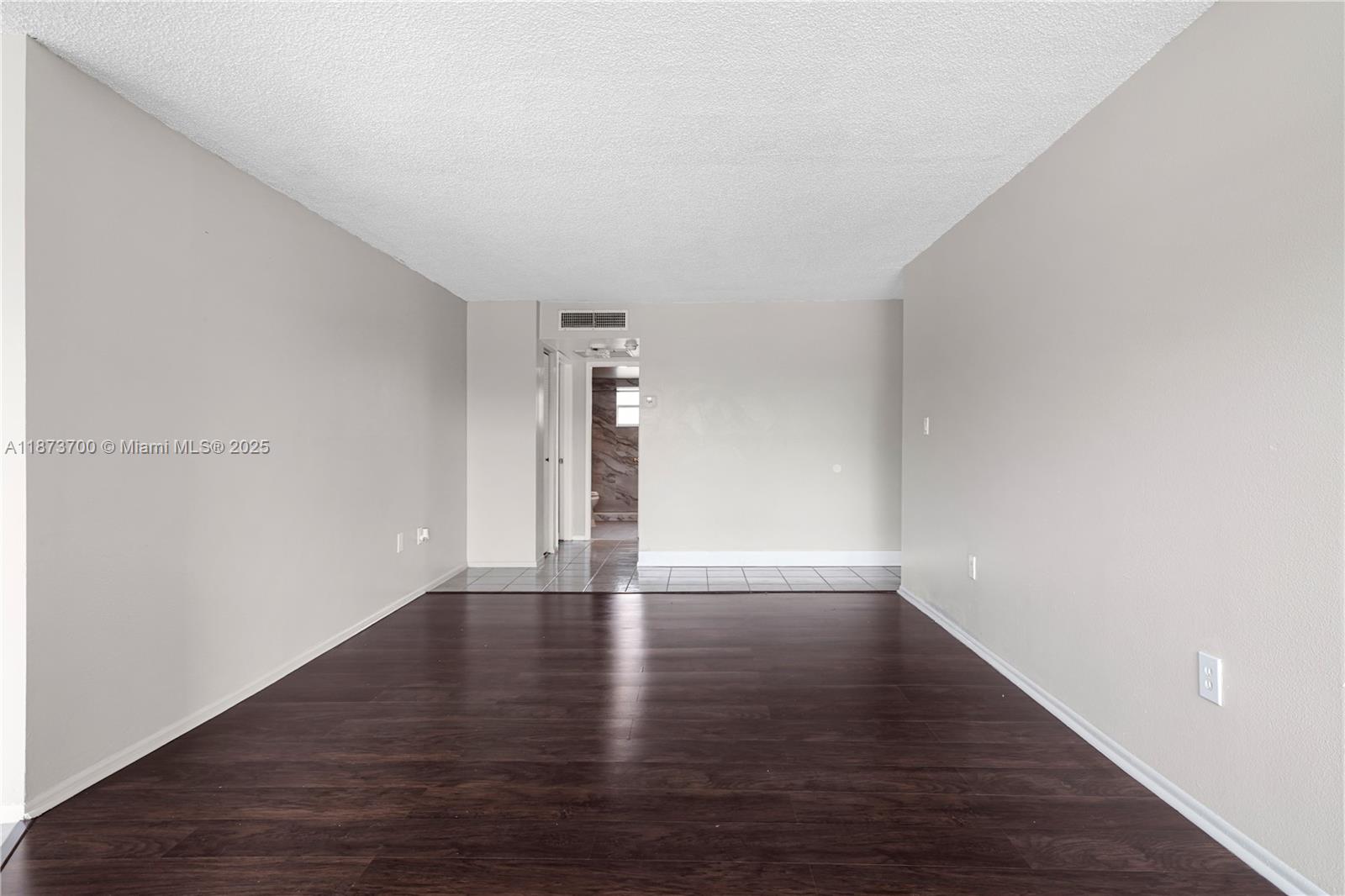 9491 Evergreen Place, Unit 207 Davie, FL 33324 - Photo 5 of 42 a view of an empty room and wooden floor