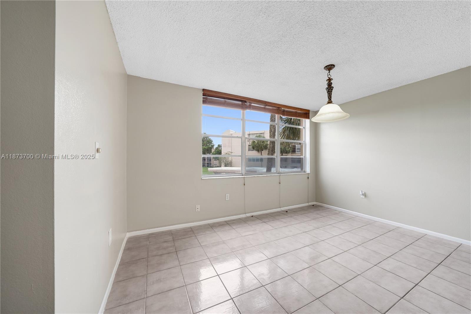 9491 Evergreen Place, Unit 207 Davie, FL 33324 - Photo 7 of 42 a view of an empty room with a window