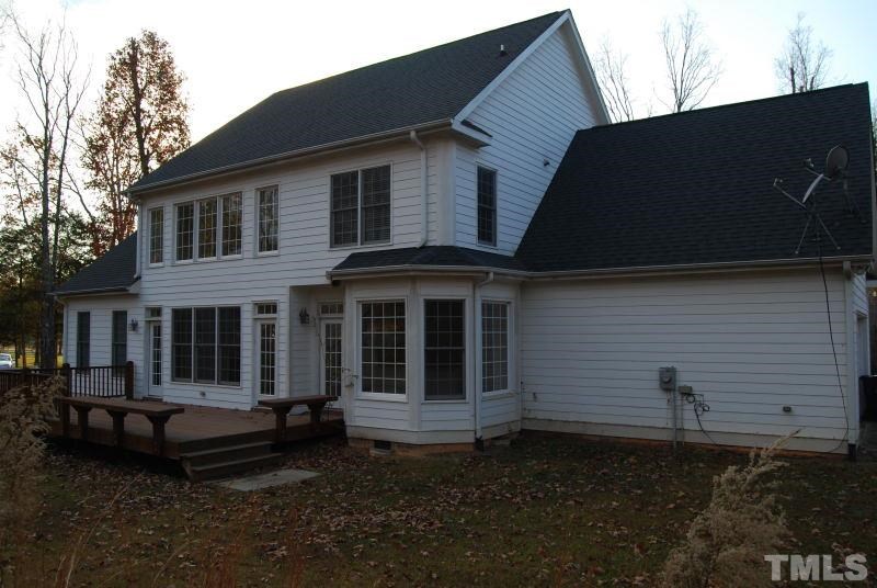 10312 Rougemont Road Bahama, NC 27503 - Photo 2 of 19 a house view with a garden space