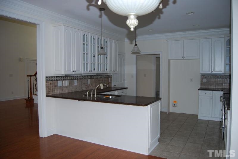 10312 Rougemont Road Bahama, NC 27503 - Photo 4 of 19 a kitchen with stainless steel appliances a refrigerator sink and cabinets
